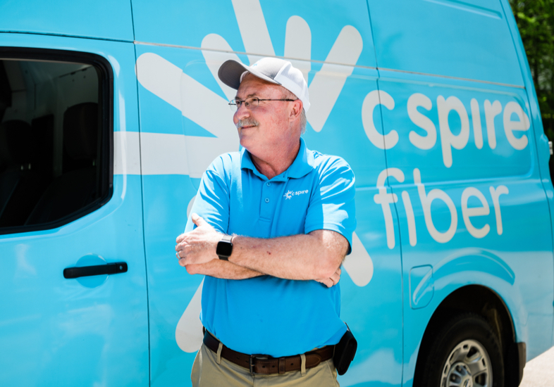 C Spire Fiber technician standing in front of fiber truck